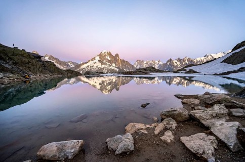 Evening mood with pink evening sky, mountain landscape with mountain hut Refuge du Lac Blanc at