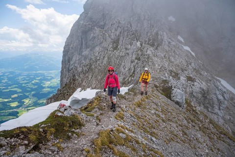 Two mountaineers with helmets in the mountains in fog, Wilder Kaiser, Kaiser Mountains, Tyrol,