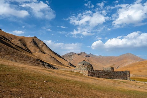 Historic caravanserai Tash Rabat from the 15th century, with yellow hills, Atbashy district in the