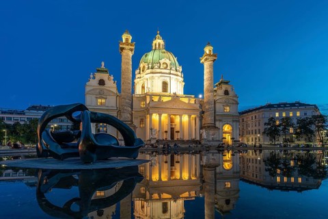 Sculpture by Henry Moore Hill Arches and the Karlskirche in Vienna at dusk, Austria, Europe