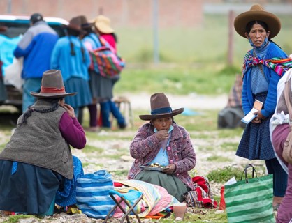 Peruvian woman in traditional traditional costume at the indigenous market in Chinchero, Cusco