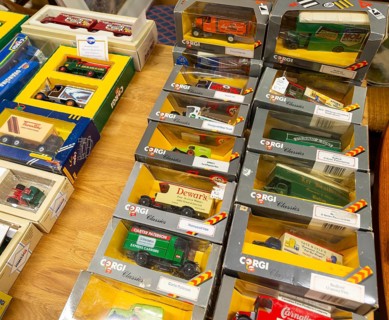 Boxes of Corgi model trucks, vans and other vehicles on display at auction, UK
