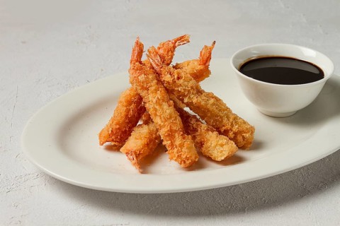 Fried shrimp, peeled in tempura, soy sauce, close-up