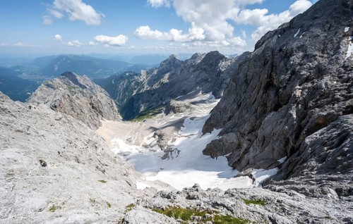 View of mountain basin with snow field of the Höllentalferner and Höllental, Zugspitze via ferrata,