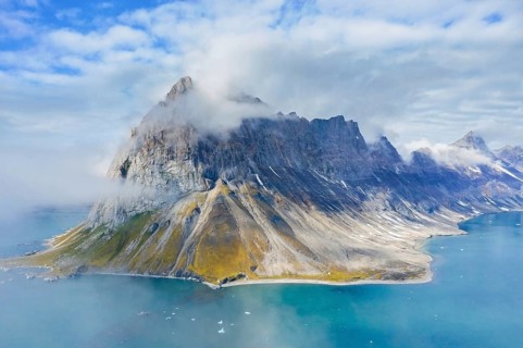 Gnalberget, mountain with steep sea cliffs in Hornsund fjord at Gnålodden in summer, Svalbard,