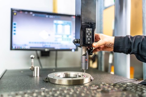 Close-up of the hand of a technician working with three-dimensional verification and measuring