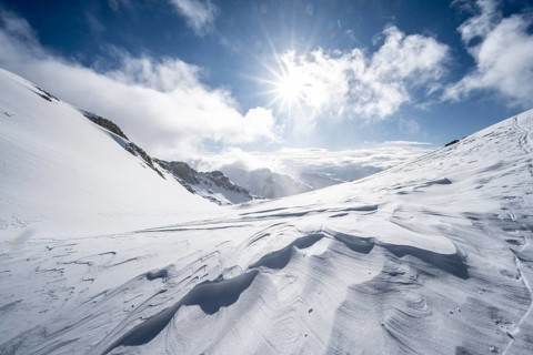 Snow-covered mountain landscape on the Wildhorn with sun star, High tour, Bernese Alps, Bernese
