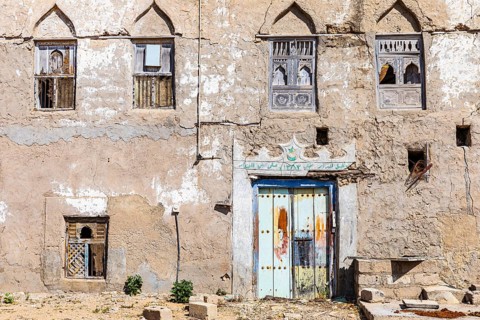 Old, weathered shutters and front door in the deserted neighbourhood of Mirbat, Dhofar Province,