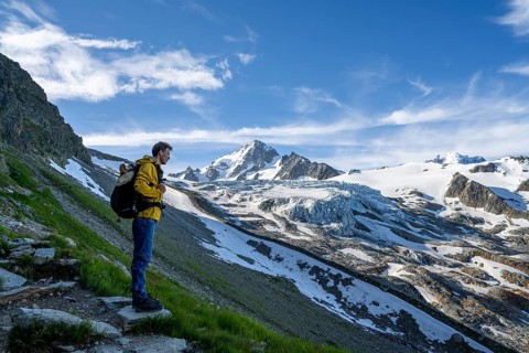 Mountaineer in front of high alpine mountain landscape, summit of the Aiguille de Chardonnet and
