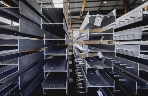 Finished galvanised steel parts lie in the factory hall of the surface finishing company Coatinc