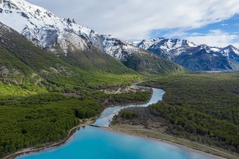 Aerial view of lake Lago Jeinimeni, river flowing out of the lake, glacial blue water in contrast