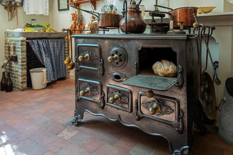 Antique cast-iron stove in kitchen inside 18th century clergy house Schriek at recreated village in