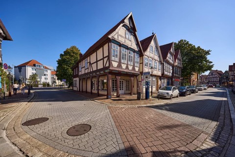 Historic half-timbered houses, city centre, concrete pavement, hard shoulder with parked cars,