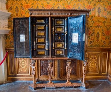 Decorative antique wooden cabinet with detailed engraving and open doors, Italian cabinet in the