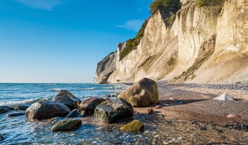 Beach with boulders at the chalk cliffs of Møns Klint on the Baltic Sea, Møn Island, Denmark,