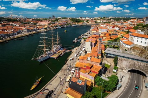Aerial view of Porto city and Vila Nova de Gaia and Douro river with moored sailling ship from Dom