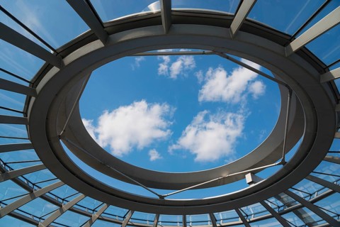 Round skylight of the dome with a view of the blue sky and clouds, Reichstag building, German