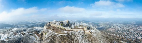 Aerial panorama of the snow-covered Hegau volcano Hohentwiel with Germany's largest castle ruins,