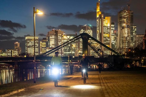 Skyline of the city centre of Frankfurt am Main, cyclist with light on the cycle path, pavement,