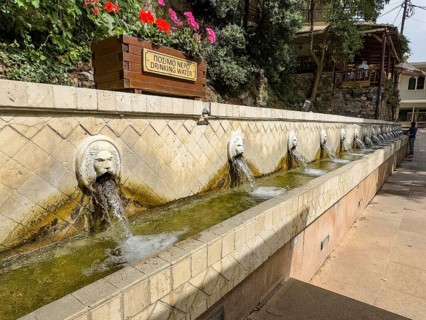 Partial view of lion fountain Venetian fountain Kefalovrisi with 25 waterspouts in the shape of