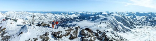 Two ski tourers on the summit of Cevedale, Alpine panorama, Aerial view, Snow-covered mountain