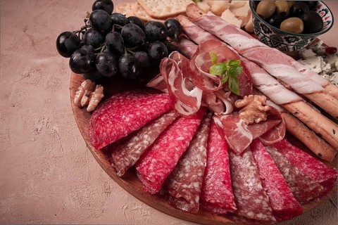 Appetizer, assortment, set, sausage, and cheese, on a wooden board, top view, no people