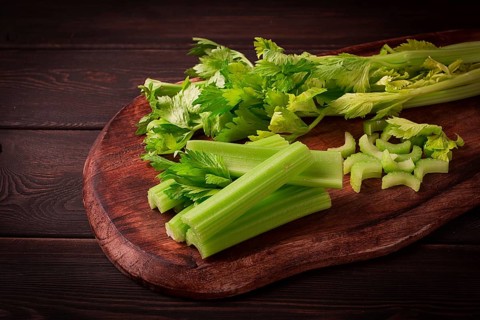 Fresh bunch of celery, top view, no people, on a dark background