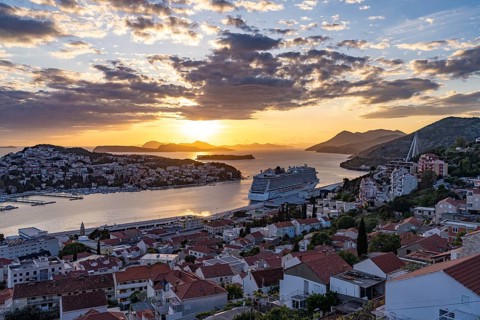 Cruise ship Norwegian Escape in the harbour of Dubrovnik at sunset, Croatia, Europe