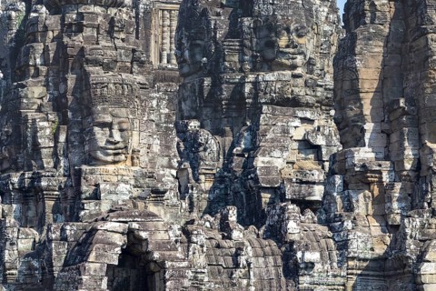 Panoramic image of giant stone-carved faces of the Bodhisattva Lokeshvara, also known as