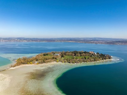 Aerial view of the island of Mainau at low tide with spring-like vegetation, district of Constance,