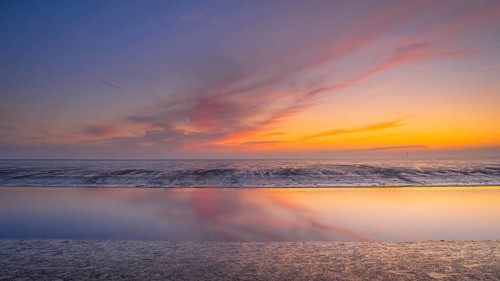 View of a tidal flat in the Wadden Sea at low tide at sunset, National Park, Unesco, World Natural