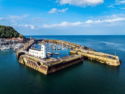 Scarborough Lighthouse and Harbour from a drone, Vincent Pier, Scarborough, North Yorkshire,