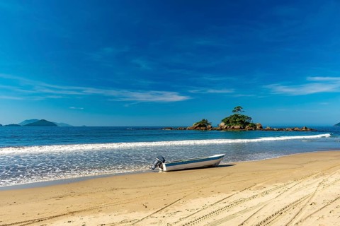 Speedboat on the sand of remote Castelhanos beach on the island of Ilhabela, Castelhanos beach,
