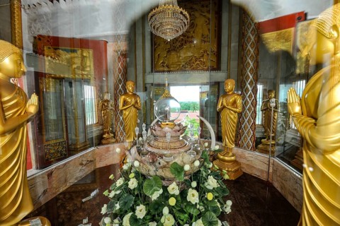 Reliquary with relics under glass in dome of tower in top of Chedi highest building in temple