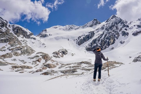 Woman hikes across a snowfield, Glaciar Vinciguerra, Ushuaia, Tierra del Fuego Province, Argentina,