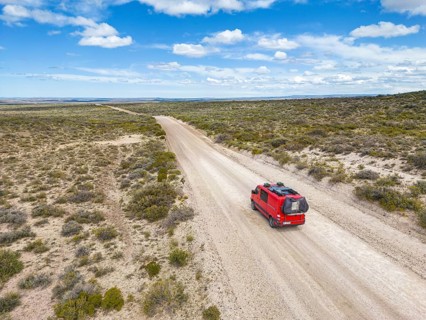 4x4 campervan drives along the road near Estancia la Maciega, Chubut, Argentina, South America