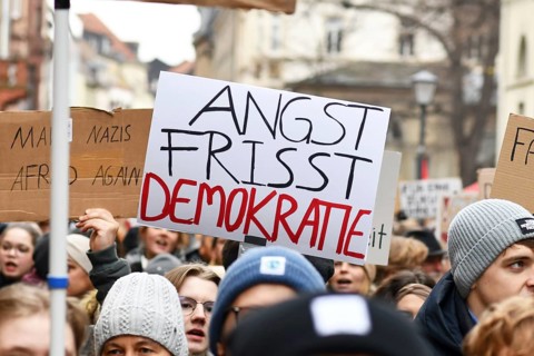 Heidelberg, Germany - February 12th 2025: Person holding up sign with text 'Fear eats democracy in