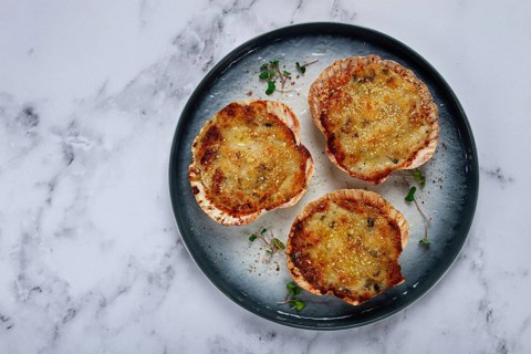 Scallop shells, stuffed, baked with cheese, in the oven, julienne with scallops