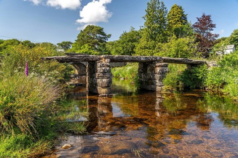 The medieval stone slab bridge Clapper Bridge in Postbridge, Dartmoor, Devon, England, Great