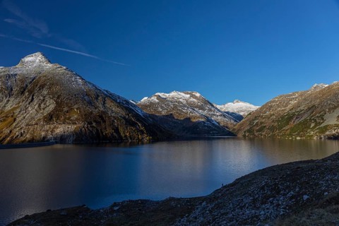 Kölnbrein reservoir and the Oberlecherspitzen mountain on a bright sunny morning. Seen from the