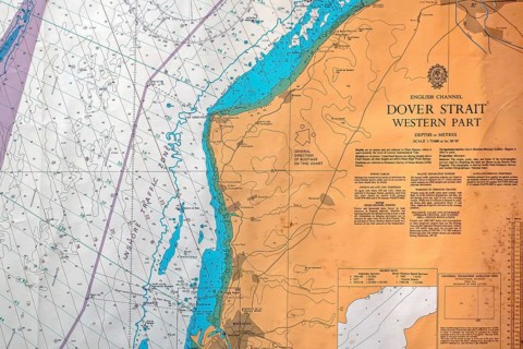 Close-up of nautical map with compass rose of the Dover Strait marking the boundary between the