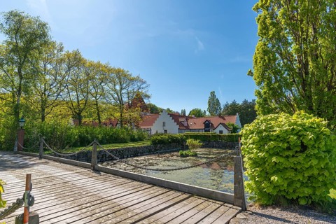 Risinge Herregaard, Ullerslev, Fyn manor house, moat, wooden bridge, trees, island of Funen,