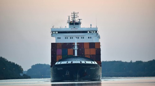Container ship Nordic Porto sailing at sunrise in the Kiel Canal, Kiel Canal, Schleswig-Holstein,