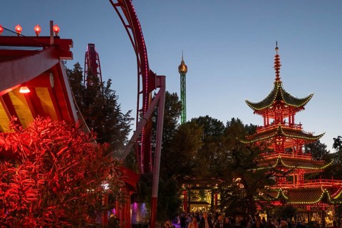 Red and yellow illuminated pagoda, roller coaster, Tivoli Amusement and Recreation Park,