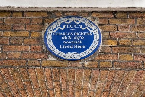 Blue plaque commemorating Charles Dickens on a brick wall, Charles Dickens Museum, 48-49 Doughty