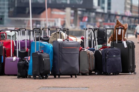 Luggage waiting to be loaded onto river cruise ships at Viking Cruise Port Amsterdam, Netherlands