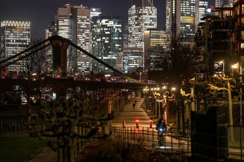 Skyline of the city centre of Frankfurt am Main, cyclist with light on the cycle path, pavement,