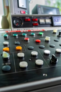 Close-up of a control panel with various round buttons and switches, Hermann Hesse railway track