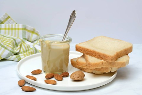 Almond cream in a jar and toast