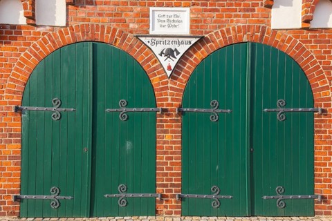 View of two green wooden gates of a fire station, Bücken, Hoya, Nienburg, Lower Saxony, Germany,